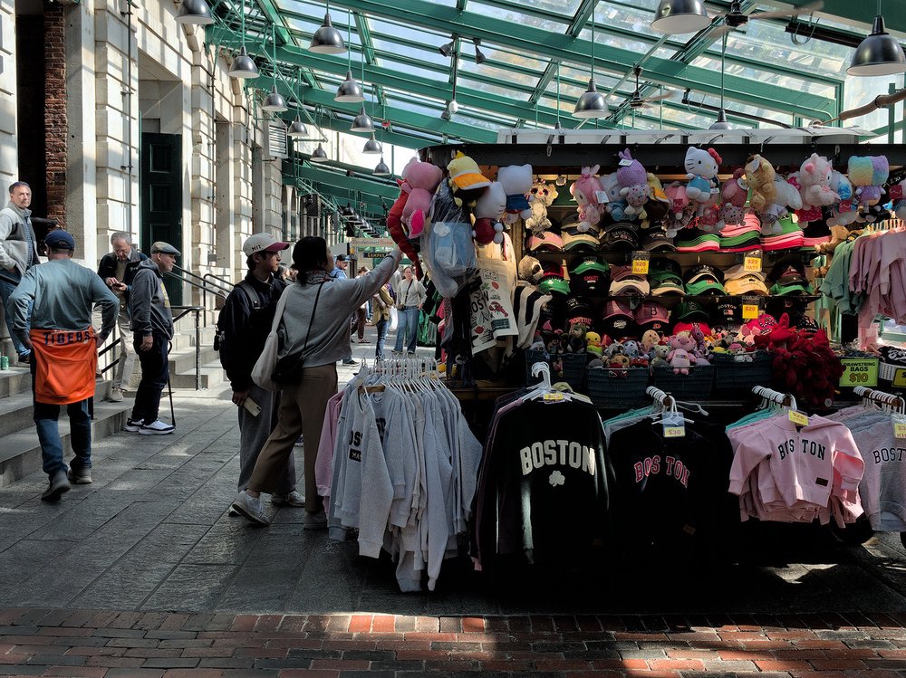 Inspecting wares at Quincy Market, Boston.