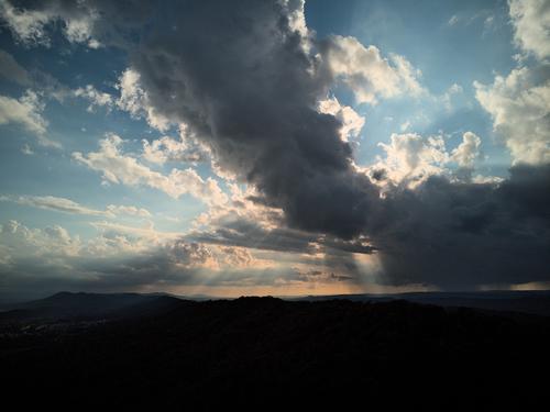 A drone's-eye view of an impressive weather system across the mountains.