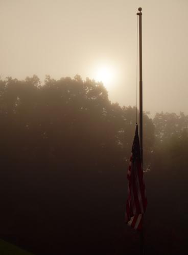 Apocalyptic Half-Staff Our flag at half-staff in honor of Dolly Parton. A mist-shrouded sunrise turned it into a near-apocalyptic scene, which seems entirely apropos when the best of humanity keeps being taken and the worst keep ruining the world, unabated.