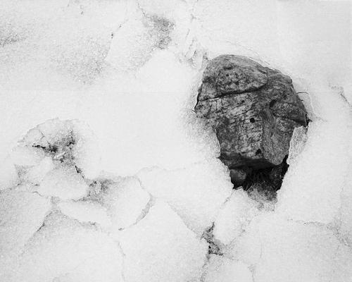 This rock, emerging from the cracked and crusted-over snow which had enveloped it, caught my eye one morning while taking our dogs out for their morning walk. As soon as I was able, I returned with the camera to photograph it.